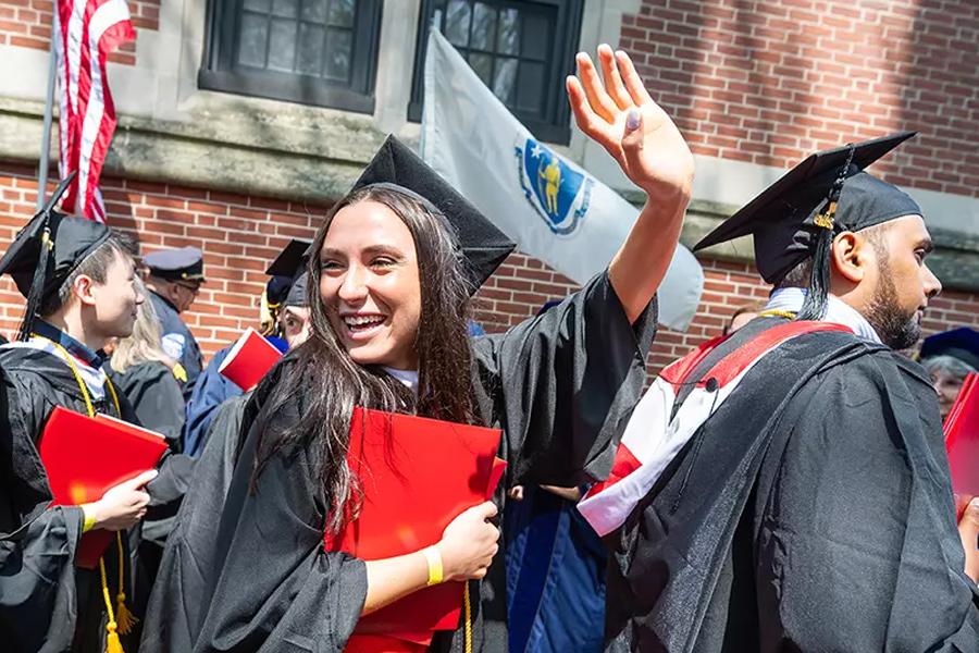 girl waving in graduation ceremony