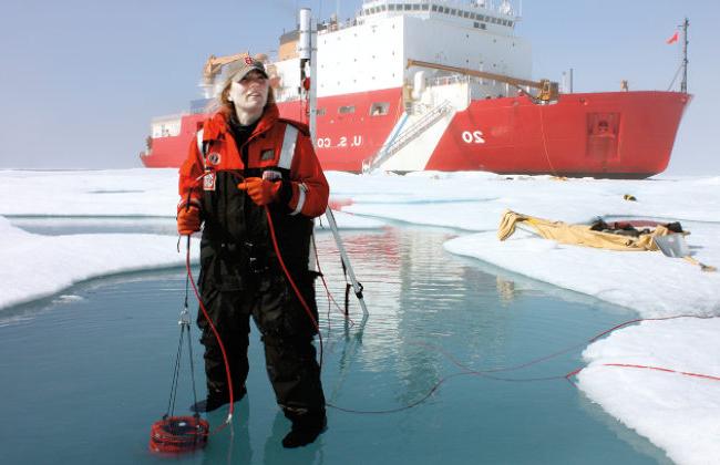 Karen Frey standing in front of large boat