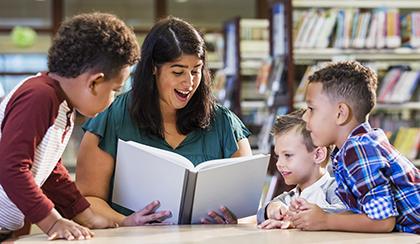 teacher reading to young students